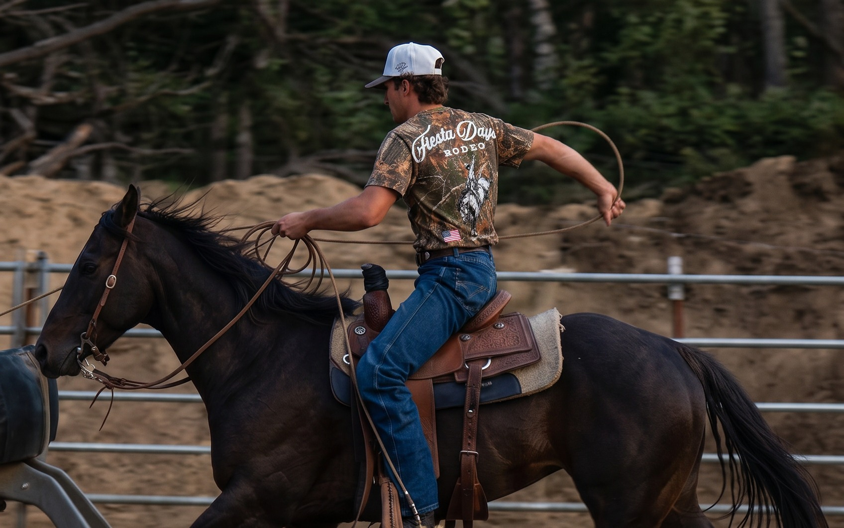 Roper on horseback wearing a Fiesta Days Rodeo camo tee