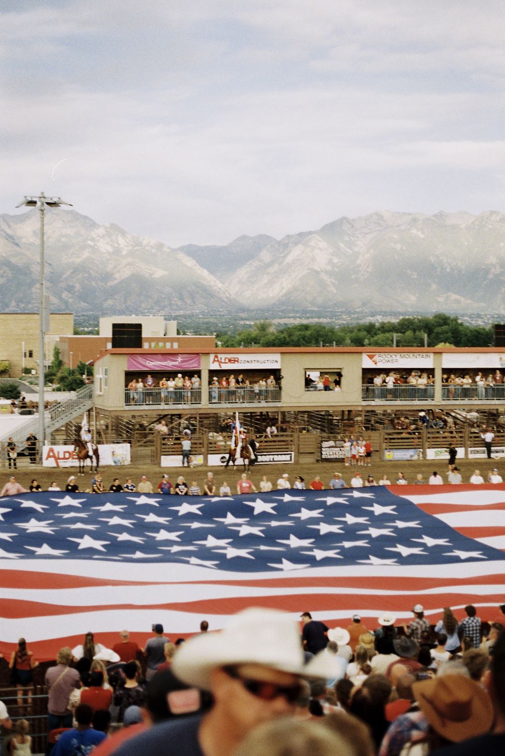 Giant American flag stretched across the arena floor during the Western Stampede opening ceremony